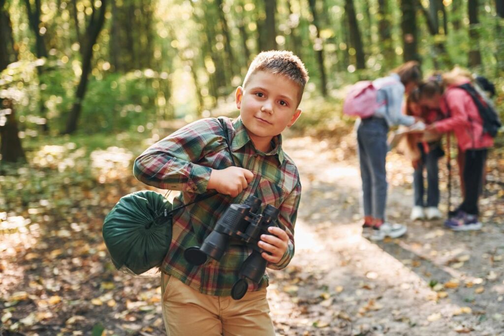 Boy with binoculars hiking