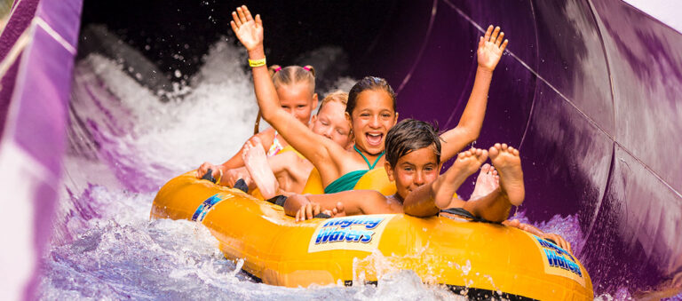 Group of children riding the Aqua Rocket slide